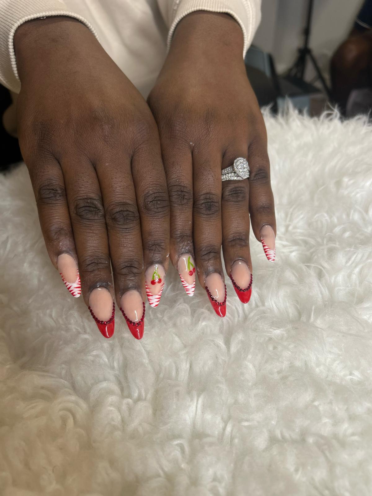 Red French tips with cherries and red rhinestones.
