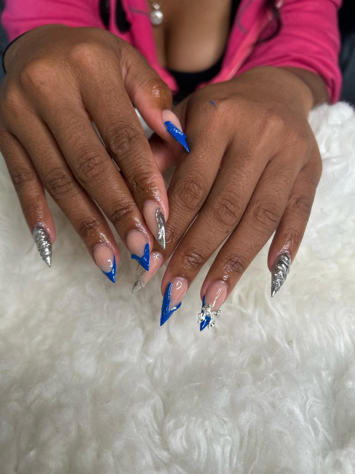 Royal blue stilettos with silver chrome accents and charms.