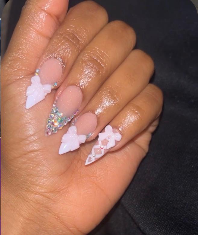 Pastel pink stilettos with bows and crystals.